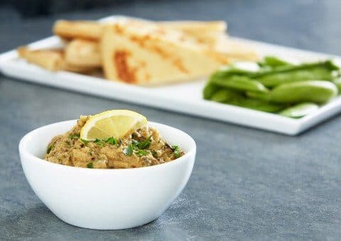 A bowl of baba ghanouj which is made with roasted eggplants