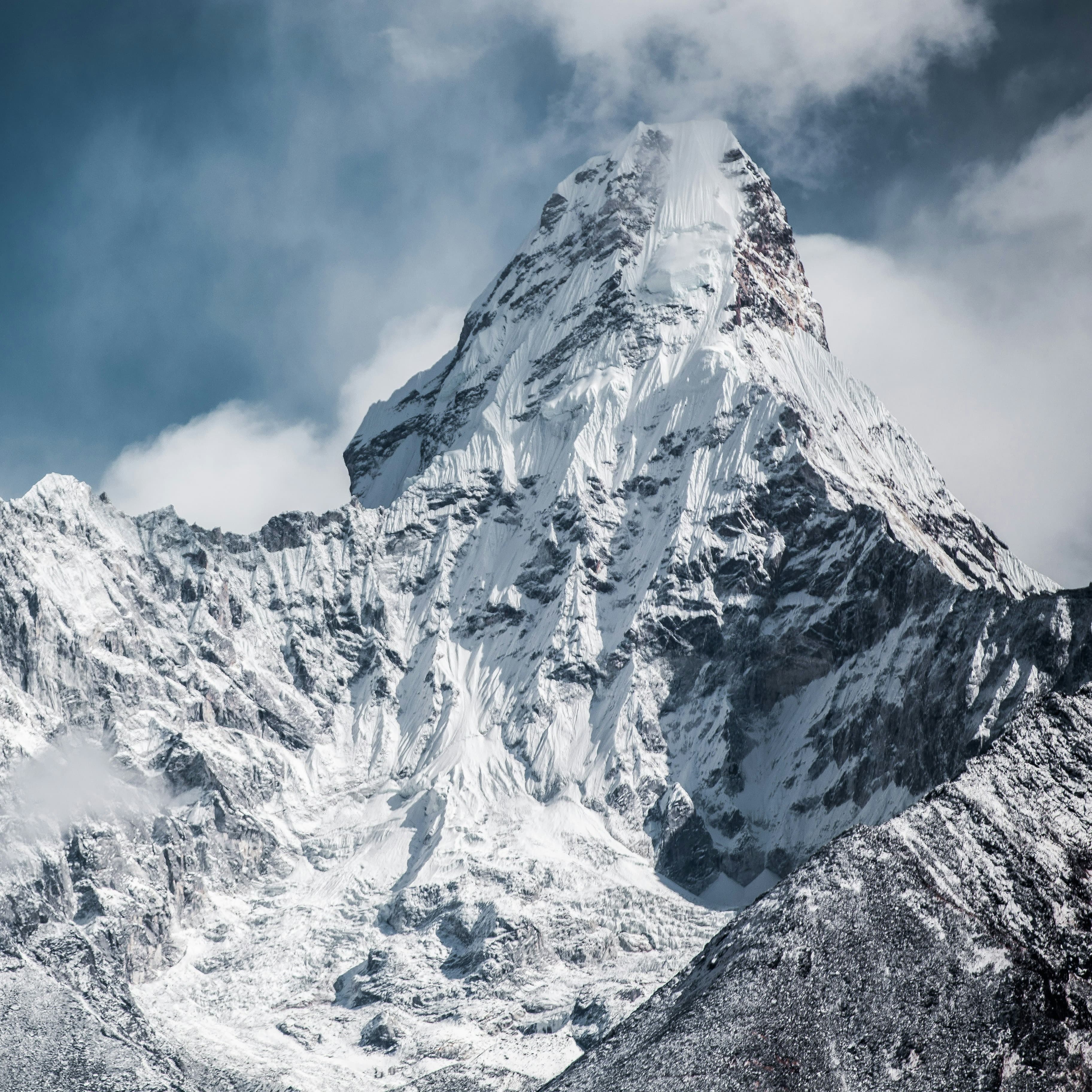 A photograph of a very tall snowy mountain peak.