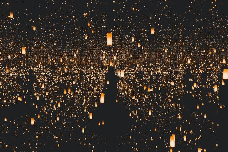 Thousands of candles reflected in the water