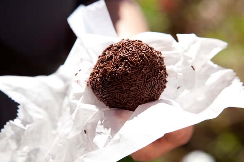 A rum ball covered in chocolate sprinkles