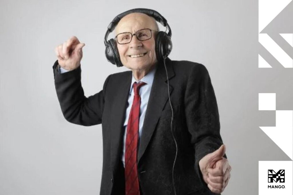 An older gentleman listening to music with headphones